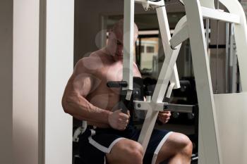 Male Bodybuilder Doing Heavy Weight Exercise For Back In Gym