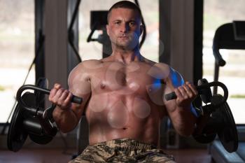 Healthy Man Working Out Biceps - Machine Concentration Curls
