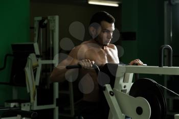 Young Man Doing Heavy Weight Exercise For Back