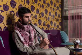 Muslim Man Smoking Shisha At Arabic Restaurant - Exhaling Smoke
