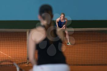 Portrait Of Two Beautiful Women Playing Tennis Indoor - Isolated On Black