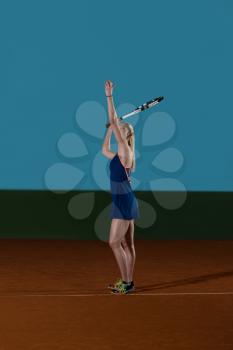 Portrait Of Woman Tennis Player With Racket Ready To Hit A Tennis Ball