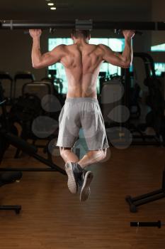 Young Male Bodybuilder Doing Heavy Weight Exercise For Back