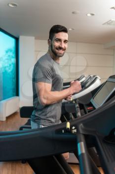 Handsome Man Running On The Treadmill In Gym