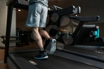 Close Up Of Male Legs Running On Treadmill - Blurred Motion