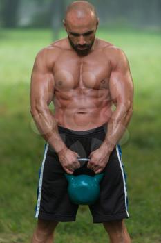 Young Fitness Male Exercise With Kettle Bell - Kettlebell Swing