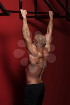 Adult Man Athlete Doing Pull Ups - Chin-Ups In The Gym