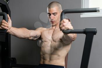 Young Bodybuilder Doing Heavy Weight Exercise For Chest