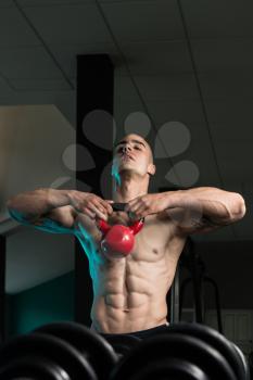 Young Man Working With Kettle Bell In A Gym