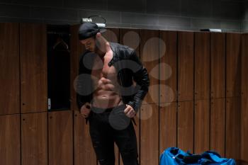 Shirtless Muscular Young Male Athlete In Leather Jacket In Gym Dressing Room