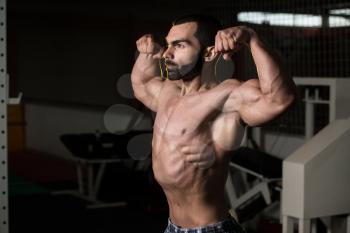 Portrait Of A Young Fit Man Showing Front Double Biceps Pose - Muscular Athletic Bodybuilder Fitness Model Posing After Exercises