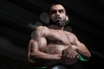 Portrait Of A Young Physically Fit Man Performing Side Chest Pose - Muscular Athletic Bodybuilder Fitness Model Posing After Exercises