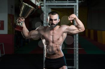 Bodybuilder Competitor Showing His Winning Medal - Male Fitness Competitor Showing His Winning Medal