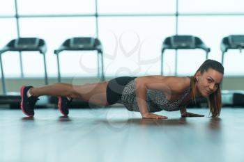 Young Woman Athlete Doing Pushups As Part Of Bodybuilding Training