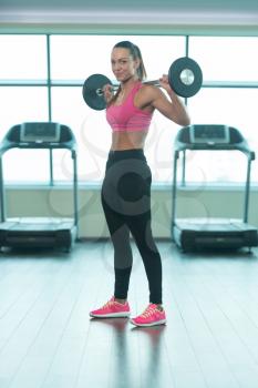 Healthy Fitness Woman Working Out Legs With Barbell In A Gym - Squat Exercise