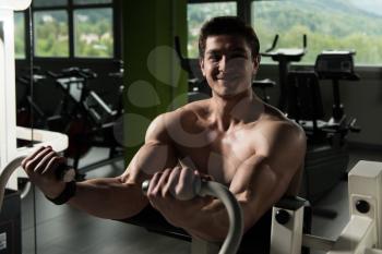 Biceps Exercise Machine - Young Bodybuilder Doing Heavy Weight Exercise For Bicep In The Gym