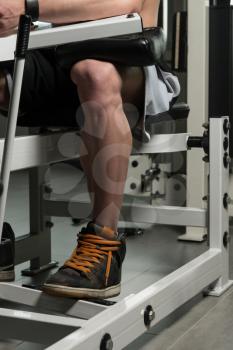 Close Up Of A Bodybuilder Doing Heavy Weight Exercise For Legs Calves