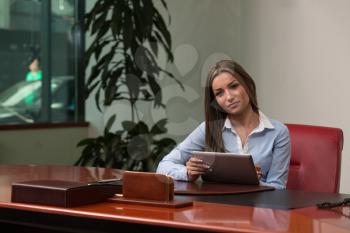 Portrait Of A Young Business Woman Using A Touchpad In The Office - Businesswoman Working Online