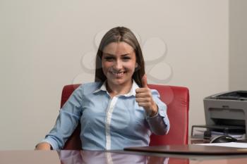 Happy Smiling Cheerful Business Woman In Office Showing Thumbs Up Gesture