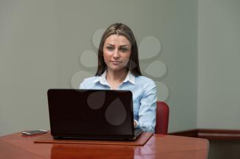 Portrait Of A Young Business Woman Using Laptop At Office - Businesswoman Working Online