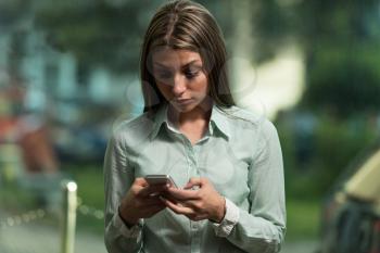 Portrait Of A Busy Sales Woman In Office And Using Her Cellphone - Businesswoman Working Online