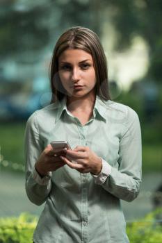 Portrait Of A Busy Sales Woman In Office And Using Her Cellphone - Businesswoman Working Online