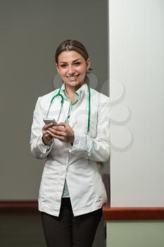 Beautiful Female Doctor Working Taking Notes On Mobile - Healthcare Worker Working Online