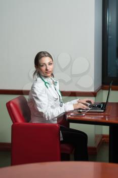 Young Pretty Female Doctor With Notebook In The Office - Successful Woman Doc At Work