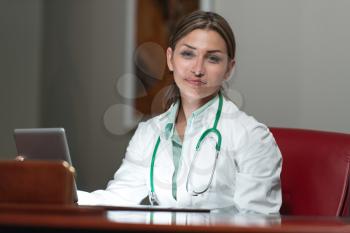 Young Pretty Female Doctor With Digital Tablet In The Office - Successful Woman Doc At Work