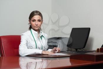 Female Doctor Writing A Letter - Notes Or Signing A Document Or Agreement
