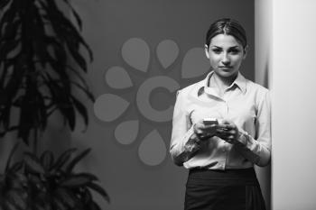 Portrait Of Young Successful Happy Business Woman In Suit Checking Her Cellphone In Office - Businesswoman Working Online