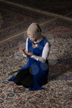 Young Muslim Woman Is Praying In The Mosque