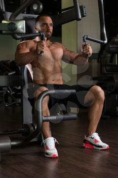 Big Man In The Gym Is Exercising Back On Machine - Muscular Athletic Bodybuilder Model Exercise In Fitness Center