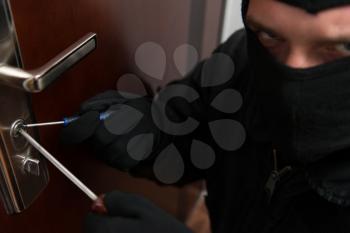 Thief Burglar Force Lock Metal Door With A Tool During House Breaking