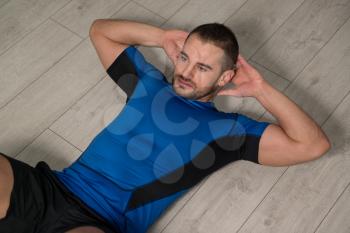 Personal Trainer Performing Abdominal Exercise On Floor - One Of The Most Effective Ab Exercises