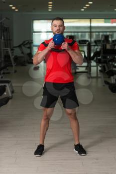 Personal Trainer Working Out With Kettle Bell In A Gym - Attractive Fitness Instructor Doing Heavy Weight Exercise With Kettle-bell