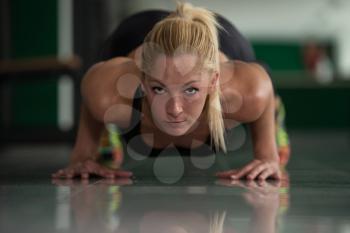 Young Woman Athlete Doing Pushups As Part Of Bodybuilding Training