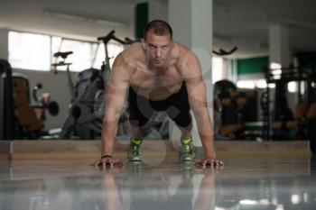 Healthy Man Athlete Doing Pushups As Part Of Bodybuilding Training