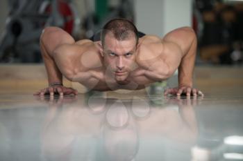 Healthy Man Athlete Doing Pushups As Part Of Bodybuilding Training