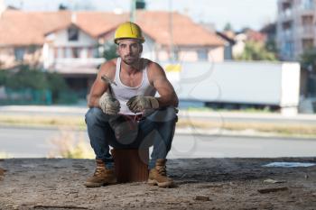 Construction Worker Relaxing The Fresh Air During Work