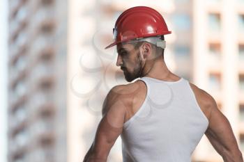 Portrait Of Handsome Male Architect Engineer With Red Helmet