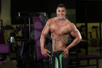 Portrait Of A Young Fit Man Showing His Well Trained Body - Muscular Athletic Bodybuilder Fitness Model Posing After Exercises