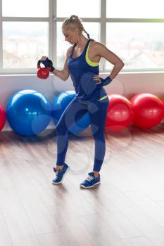 Healthy Woman Working With Kettle Bell In A Gym - Kettle-bell Exercise