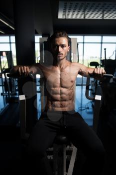 Handsome Bodybuilder Doing Heavy Weight Exercise For Chest On Machine