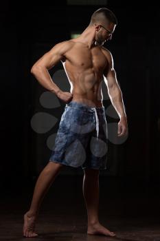 Portrait Of A Young Physically Fit Nerd Man Showing His Well Trained Body - Muscular Athletic Bodybuilder Fitness Model Posing After Exercises