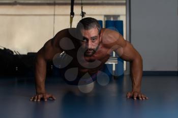 Italian Adult Athlete Doing Push Ups As Part Of Bodybuilding Training With Trx Fitness Straps