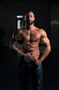 Portrait Of A Sexy Muscular Man In Pants Posing After Exercise In Gym