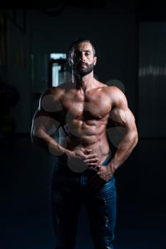 Portrait Of A Sexy Muscular Man In Pants Posing After Exercise In Gym