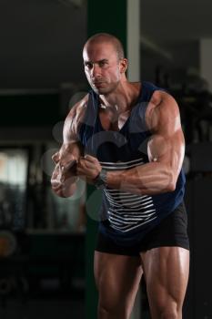 Young Bald Man Standing Strong In The Gym And Flexing Muscles - Muscular Athletic Bodybuilder Fitness Model Posing After Exercises
