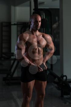Bodybuilder Posing In Different Poses Demonstrating Their Muscles - Male Showing Muscles Straining - Beautiful Muscular Body Athlete